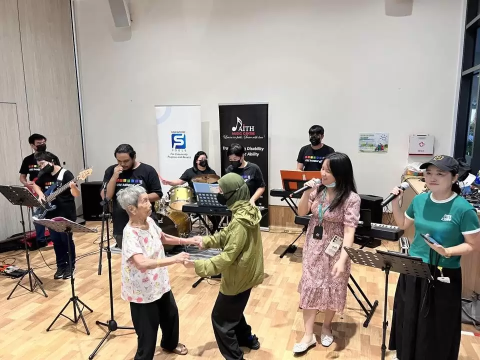 Senior learner dancing as the Faith Music Centre band performs